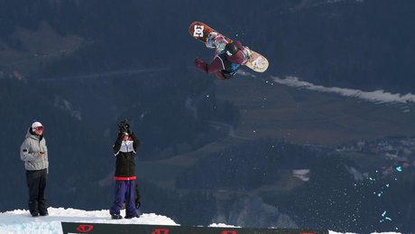 Snowboarder doing flippy-spinny things